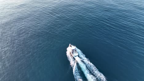 drone shot of a motorboat in the mediterranean sea on the coast of spain