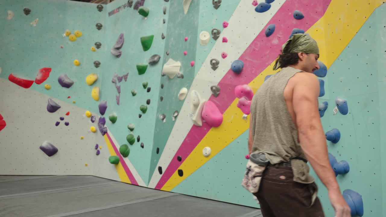 Man Covered His Hands With Chalk Powder To Improve Grip On Climbing Holds. - medium shot