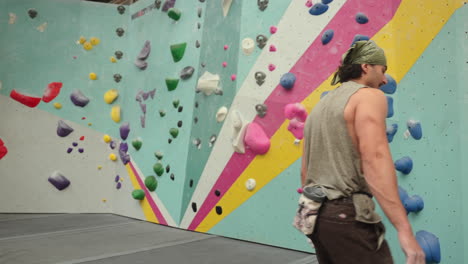 man covered his hands with chalk powder to improve grip on climbing holds. - medium shot