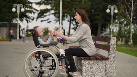 Mother-and-daughter-with-spinal-paralysis-play-patty-in-park