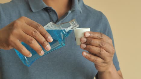 pouring mouthwash