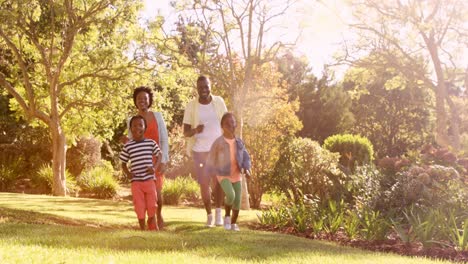 Cute-family-is-running-in-a-park-