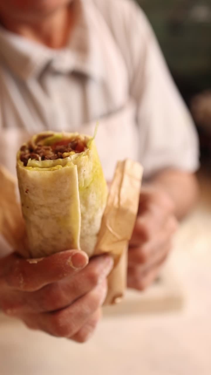 Une personne tenant un burrito