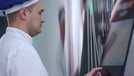 factory engineer working with touch screen of industrial computer equipment