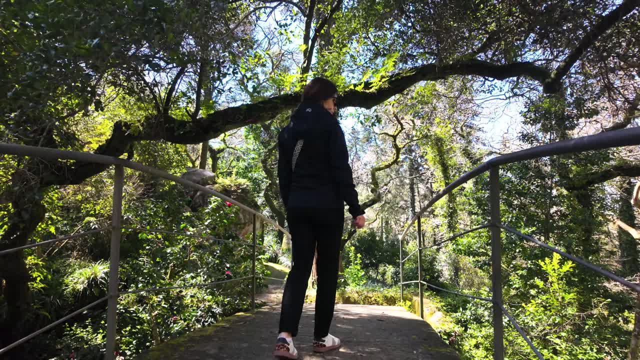 Slowmotion video of woman walking in Sintra park near Pena Palace