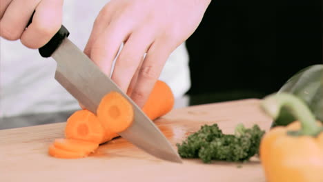 Woman-cutting-a-carrot-into-slivers-in-slow-motion