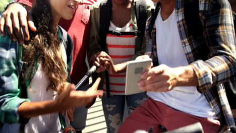 Young-hipster-are-looking-a-smartphone-and-laughing-