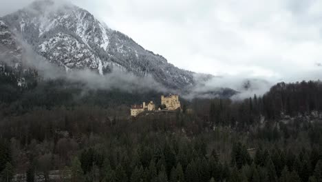 aerial view of hohenschwangau castle on foggy winter day