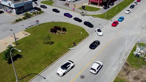 sports cars leaving parking lot in a line