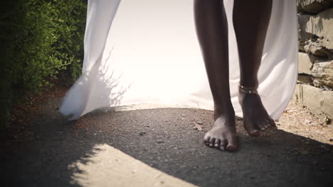 Beautiful-African-woman-walking-barefoot-in-a-courtyard