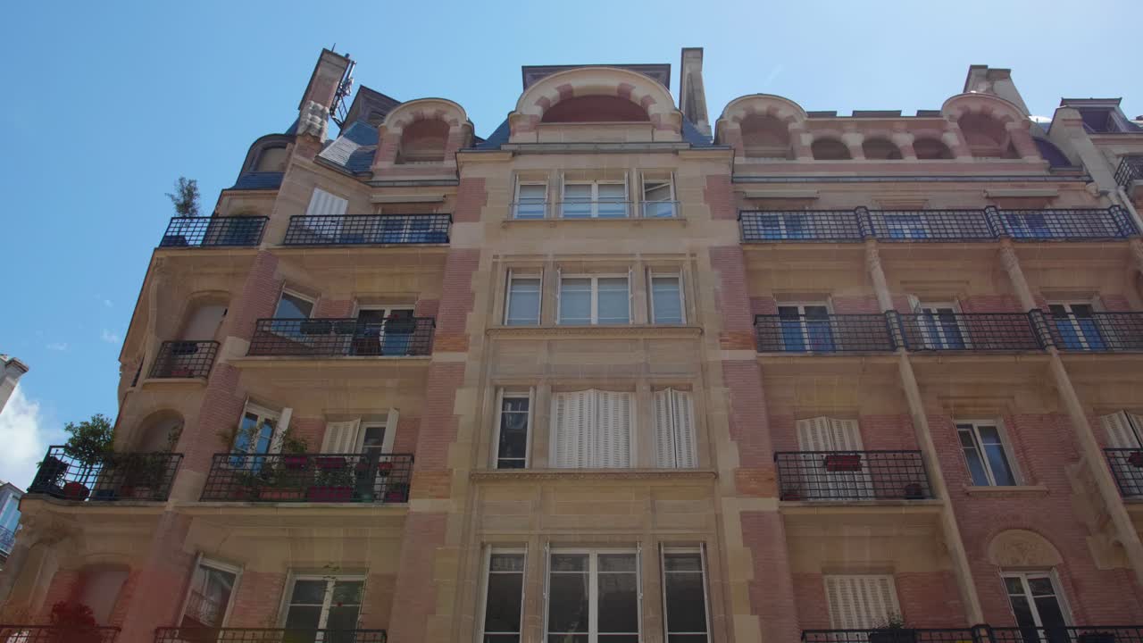 Apartment Building With Original Loggia At 6 Rue Villaret de Joyeuse In Paris, France. low angle