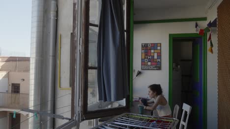 a woman enjoying her morning coffee with a amazing view through the window