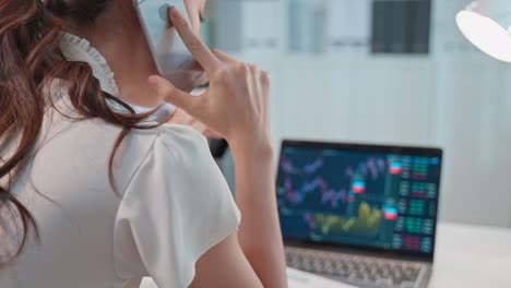 businesswoman on phone call, analyzing stock market data