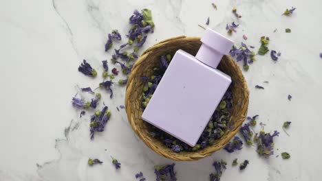 purple perfume bottle with dried lavender flowers