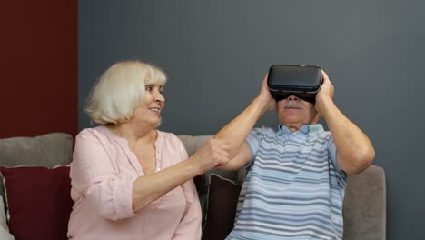 elderly couple having fun playing a vr game