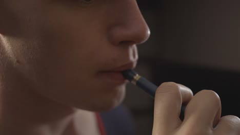 young man vaping an electronic cigarette