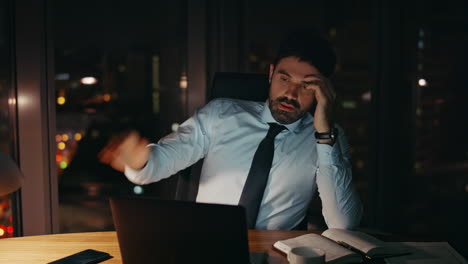 stressed businessman yelling smartphone sitting office desk late evening closeup