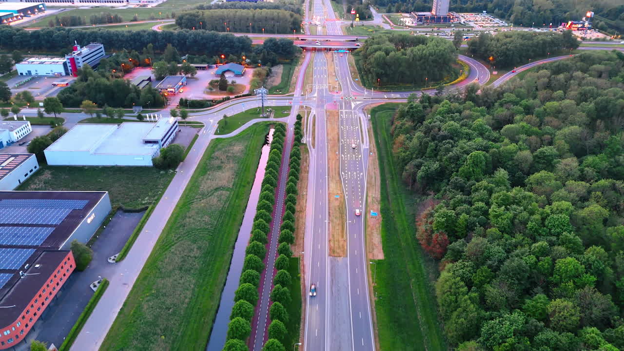 Modern highways crossing the countryside. Drone footage over the roads at sunset time.