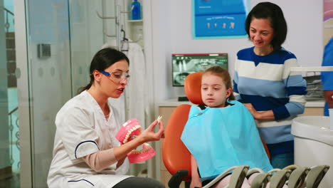 Stomatologist-explaining-to-child-the-surgery-using-a-plaster-model-of-the-mandible