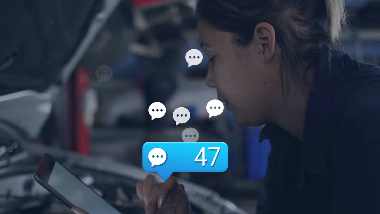 female technician tapping tablet inside automotive workshop, with chat bubbles and notification 47