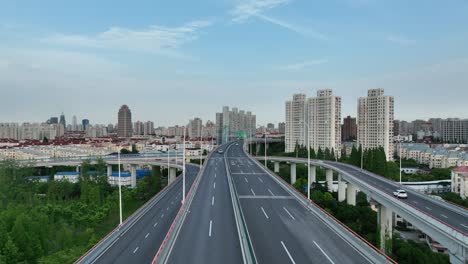 drone aerial view of traffic and highway in the city during sunset