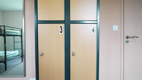 vertical panning shot of locker cabinet with numbering on compartments