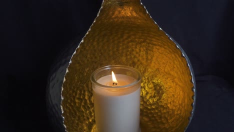 Slow-dolly-zoom-flickering-candle-in-metal-orb-holder,-peaceful,-meditate