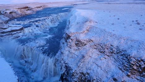 aerial view of frozen gulfoss waterfall in iceland with wild river