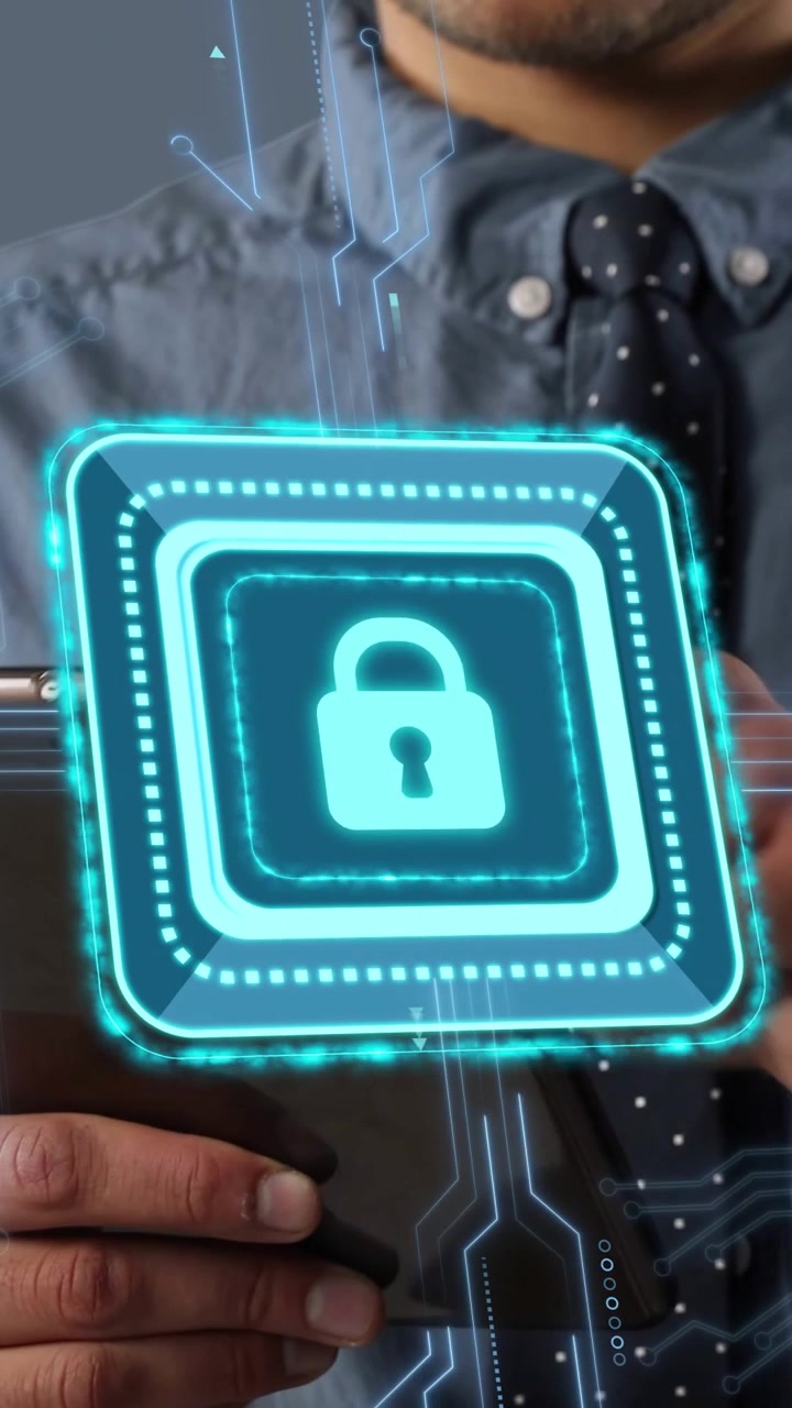 Vertical video: Man presenting tablet, hologram padlock appearing, pulsing, locking for security