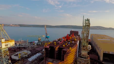 an aerial over a shipyard with large boats being built in croatia 4