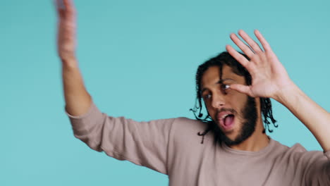 ecstatic person has fun, throwing hands in air, celebrating, studio background