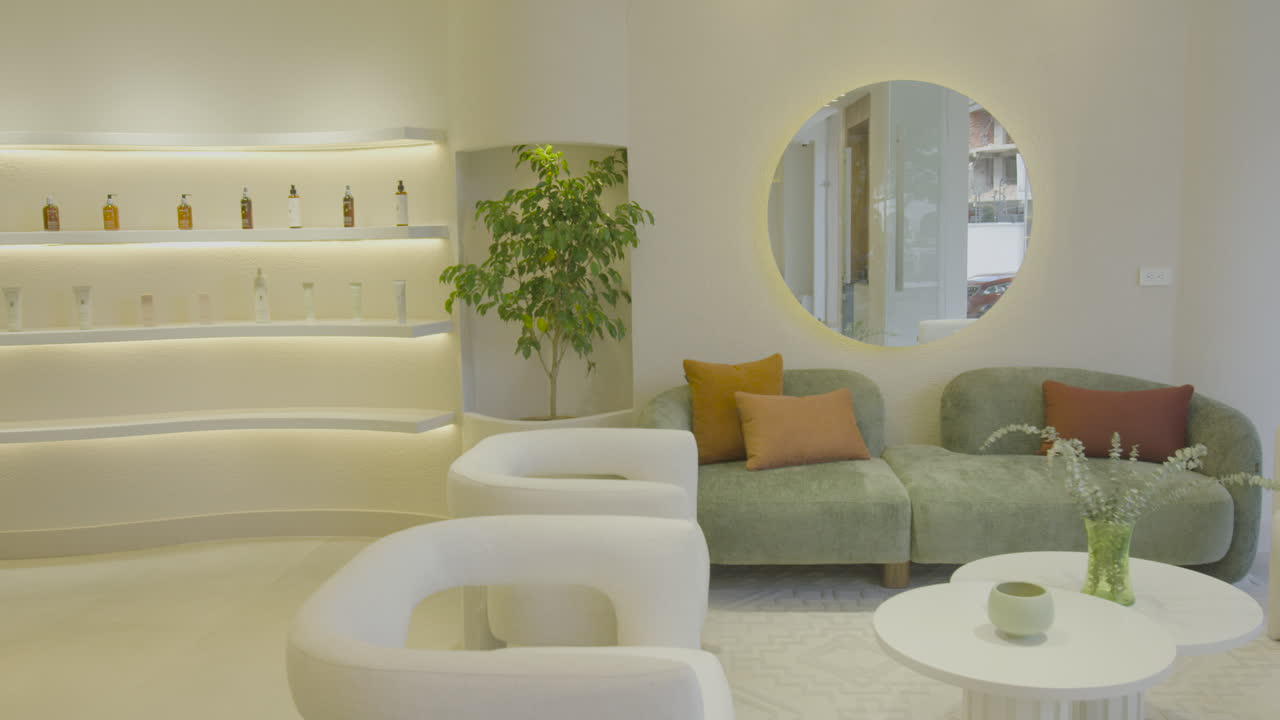 Panning clip from a modern waiting room to a professional woman walking with a tablet in hand, approaching the entrance.