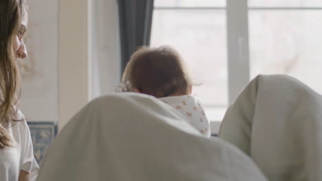 Happy-Father-Laughing-And-Playing-With-His-Little-Daughter-In-Bed-On-Sunday-Morning