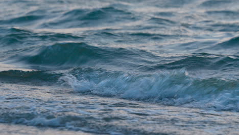 a close-up view of wavelets hitting the beach for tranquility and relaxation