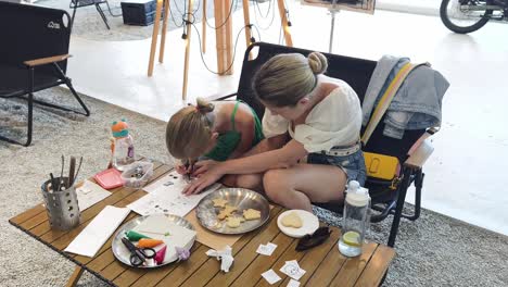 mother and daughter decorating cookies