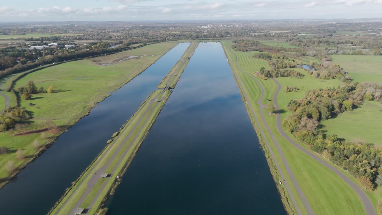 Flyover of Dorney Lake, a venue for rowing events, showcasing linear pathways and waterbody symmetry, Windsor, UK