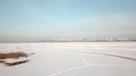 frozen lake with cityscape view