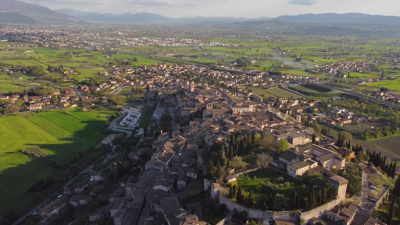 Aerial view of Spello's village, Umbria, Italy, backwards shot, sunny, 4k