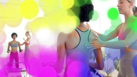 exercising in fitness studio, women surrounded by colorful bokeh animation