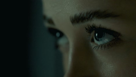 extreme macro profile closeup of a woman’s eyes during indoor cycling, capturing every detail of her focused gaze, with cinematic light enhancing the beauty and intensity of her concentrated stare