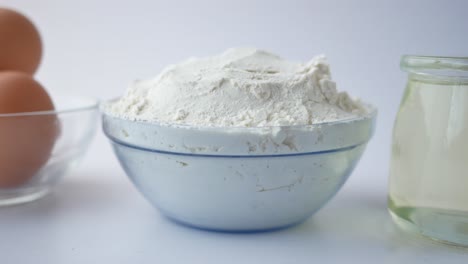 wheat flour , cooking oil and egg on white background