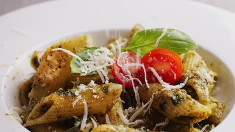 penne pasta with pesto, basil, and tomatoes