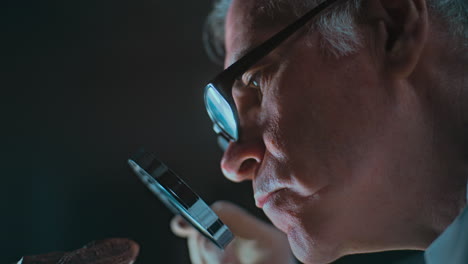 scientist examining a specimen with a magnifying glass