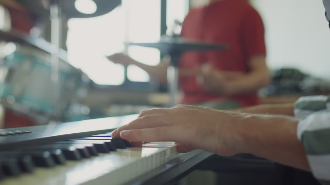 Musician playing drums during a band rehearsal
