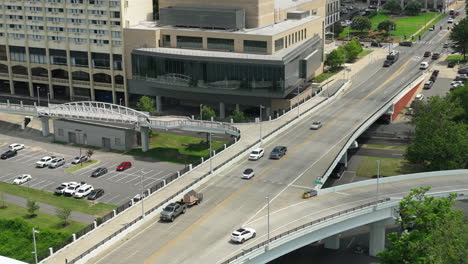 Zoom-out-pull-back-revealing-vehicle-traffic-crossing-Broadway-Bridge-over-Arkansas-River,-downtown-Little-Rock,-Arkansas---Hyperlapse