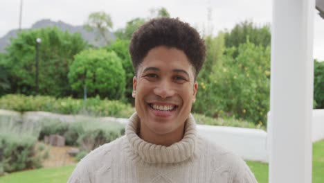 Video-of-happy-biracial-men-smiling-in-the-garden