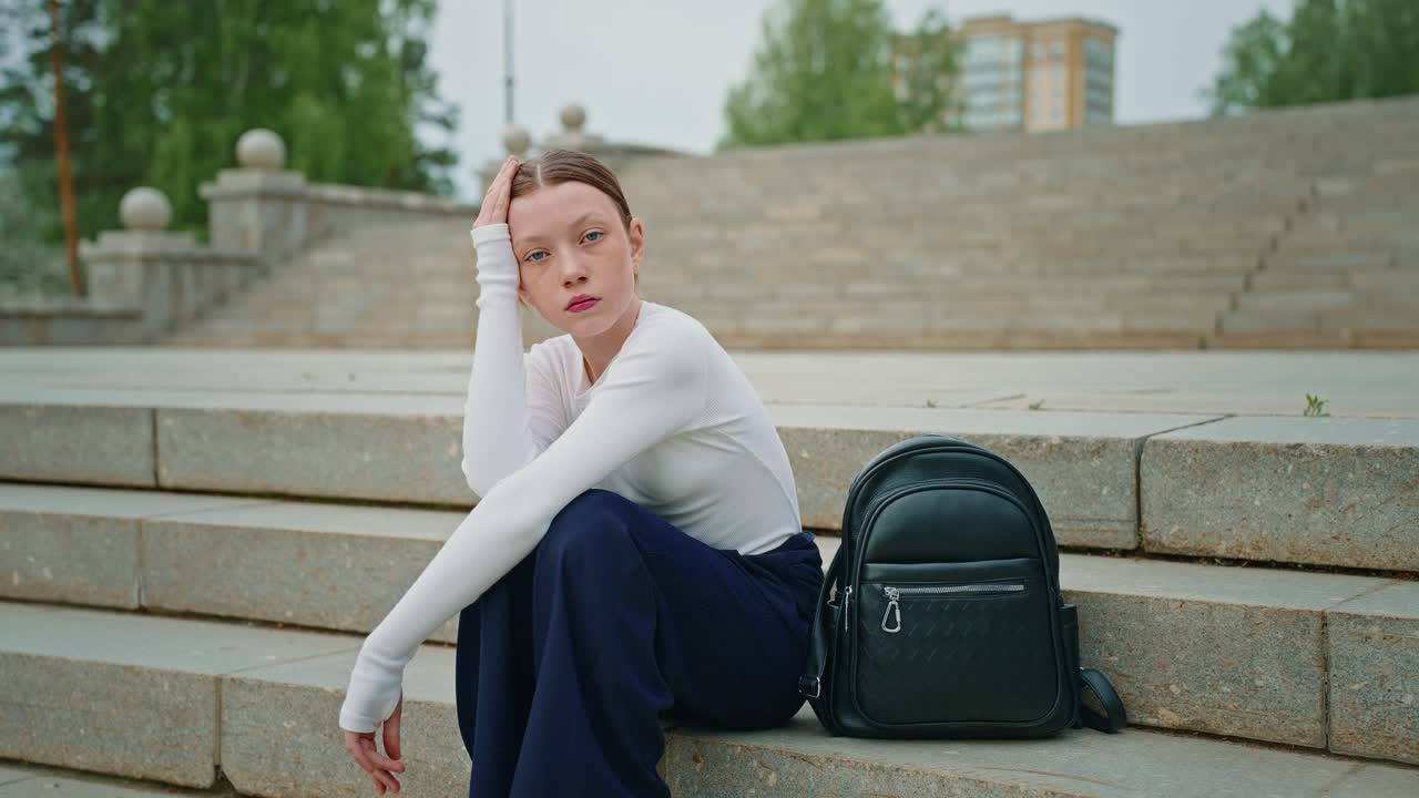 Teenager Sitting on Stairs