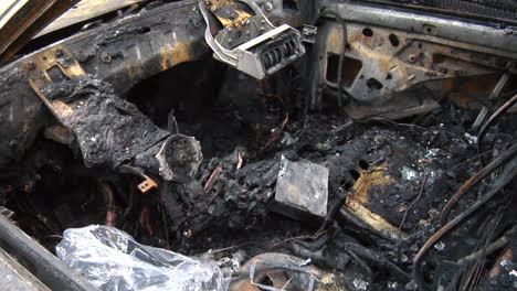 remains of a burned house and car destroyed by a house fire