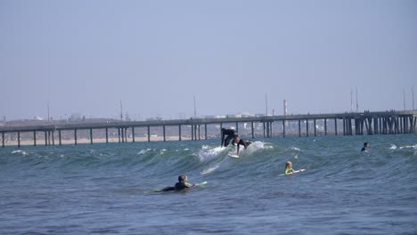 surfers riding waves in la