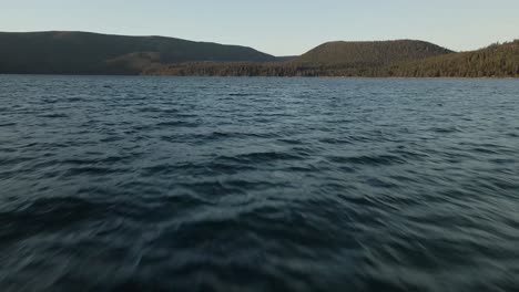 low aerial shot over the remote paulina lake in central oregon